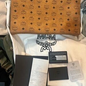 MCM Brown and Black Clutch with Iconic Monogram Design